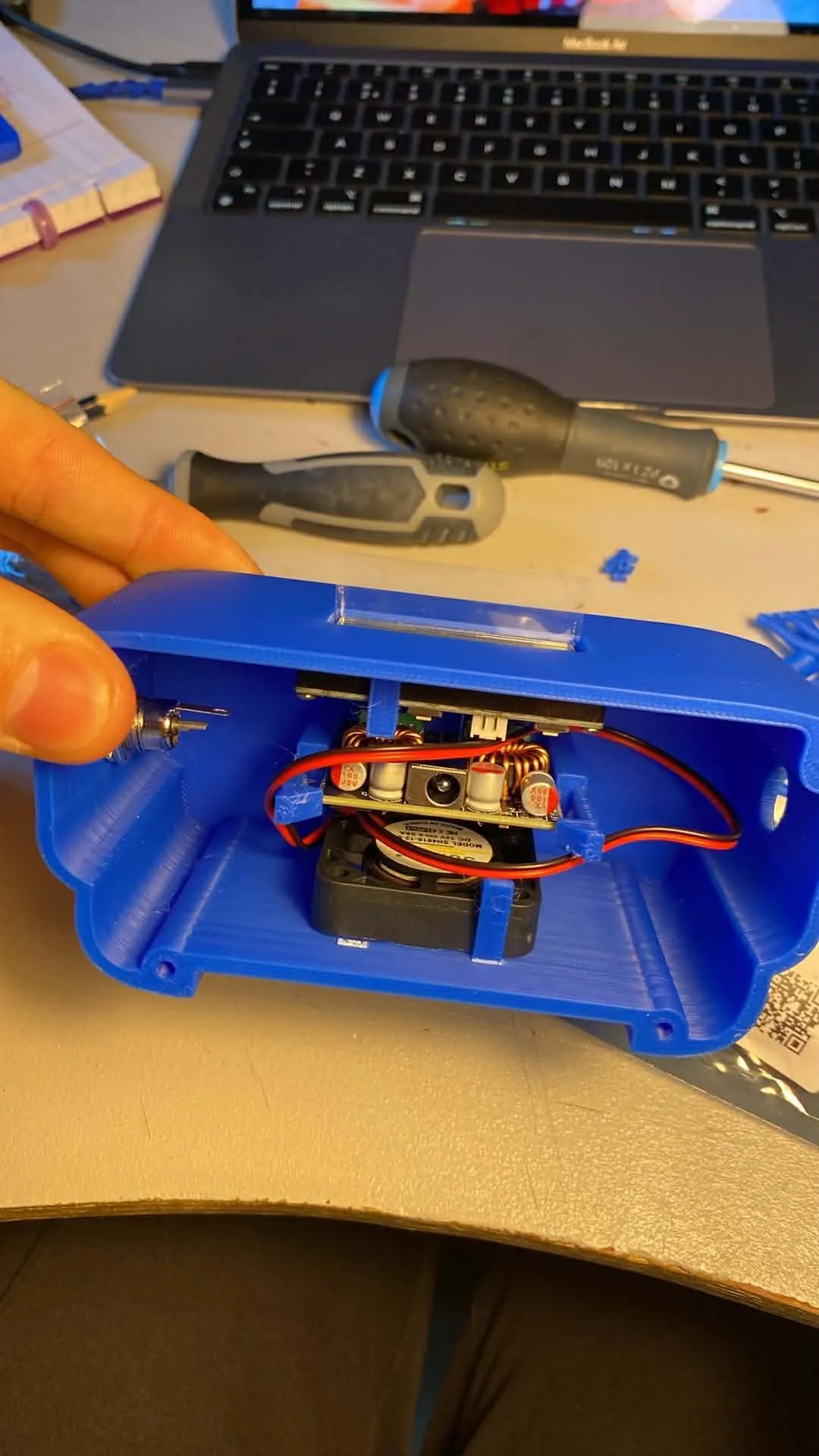The opened USB module with the buck-converter board, inductors and cooling fan inside the 3D-printed shell.