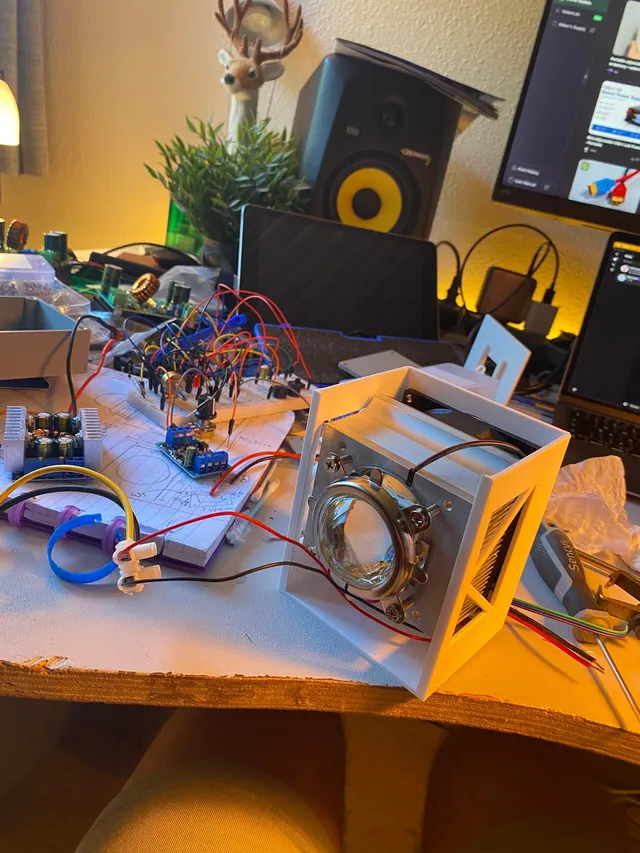 The open 3D-printed LED head showing the COB LED behind its glass optic and heatsink.
