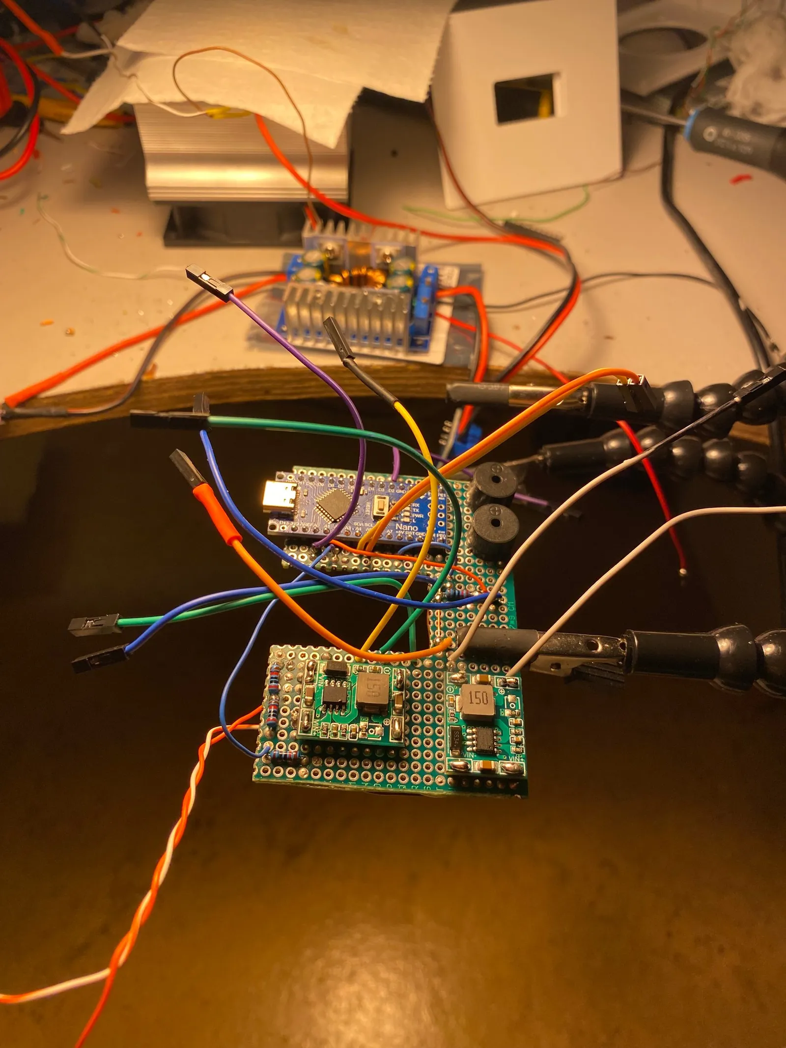 The soldered protoboard with the Arduino Nano, buck/PWM converters, buzzer and all connector for the sensors and other components.